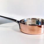 Image of a Georg Jensen copper sauté pan designed by Henning Koppel offered in this advertisement.