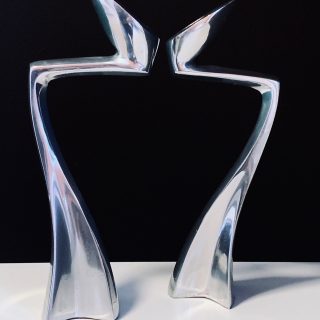Image of the Matthew Hilton Swan Arclumis candle holders offered in this advertisement.