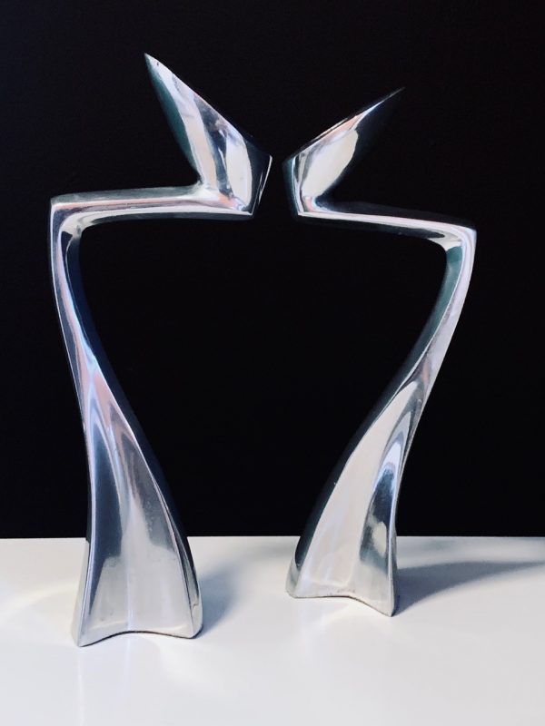 Image of the Matthew Hilton Swan Arclumis candle holders offered in this advertisement.