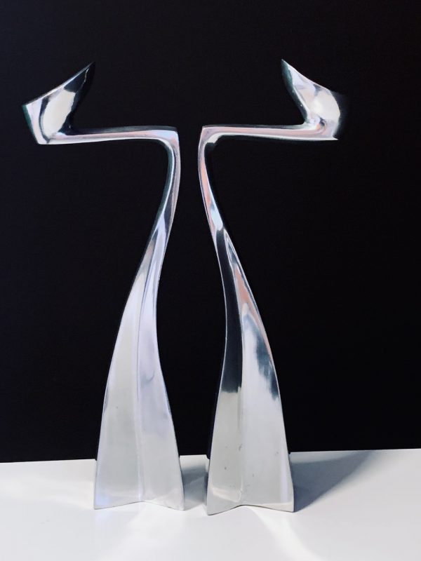 Image of the Matthew Hilton Swan Arclumis candle holders offered in this advertisement.