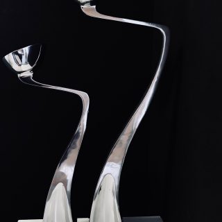 Image of the Matthew Hilton Swan Arclumis candle holders offered in this advertisement.
